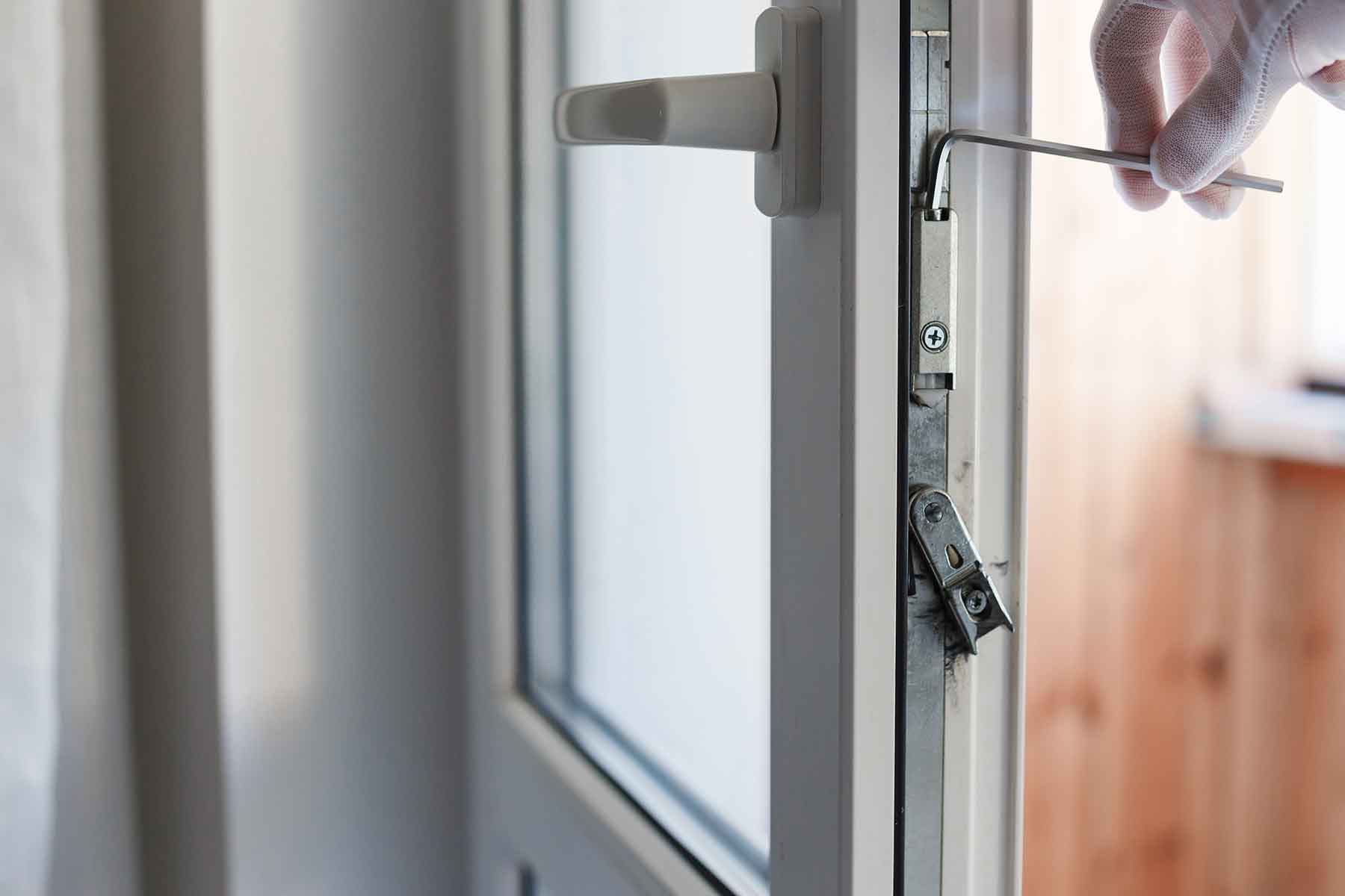 mans-hand-makes-adjustment-of-hardware-of-the-upvc-Q9TE3ZY